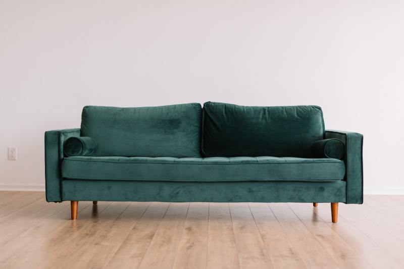 Green sofa with wooden legs